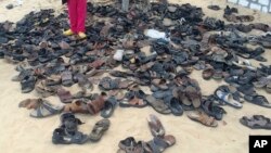 FILE - Discarded shoes of victims remain outside al-Rawdah mosque in Bir al-Abed, northern Sinai, Egypt, a day after attackers killed hundreds of worshippers, Nov. 25, 2017.