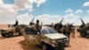 FILE- Troops loyal to Libya's internationally recognized government patrol the area in Zamzam, near Abu Qareen, Sept. 15, 2020. 