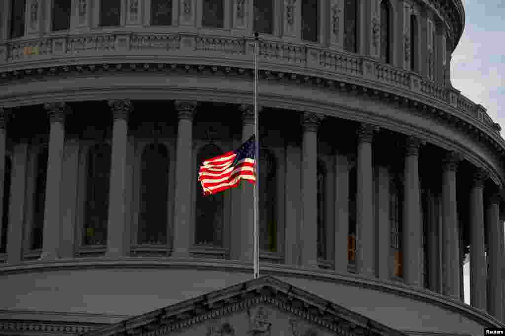 The U.S. flag flies at half staff prior to the arrival of the casket of former U.S. President George H.W. Bush at the U.S. Capitol in Washington, Dec. 3, 2018.