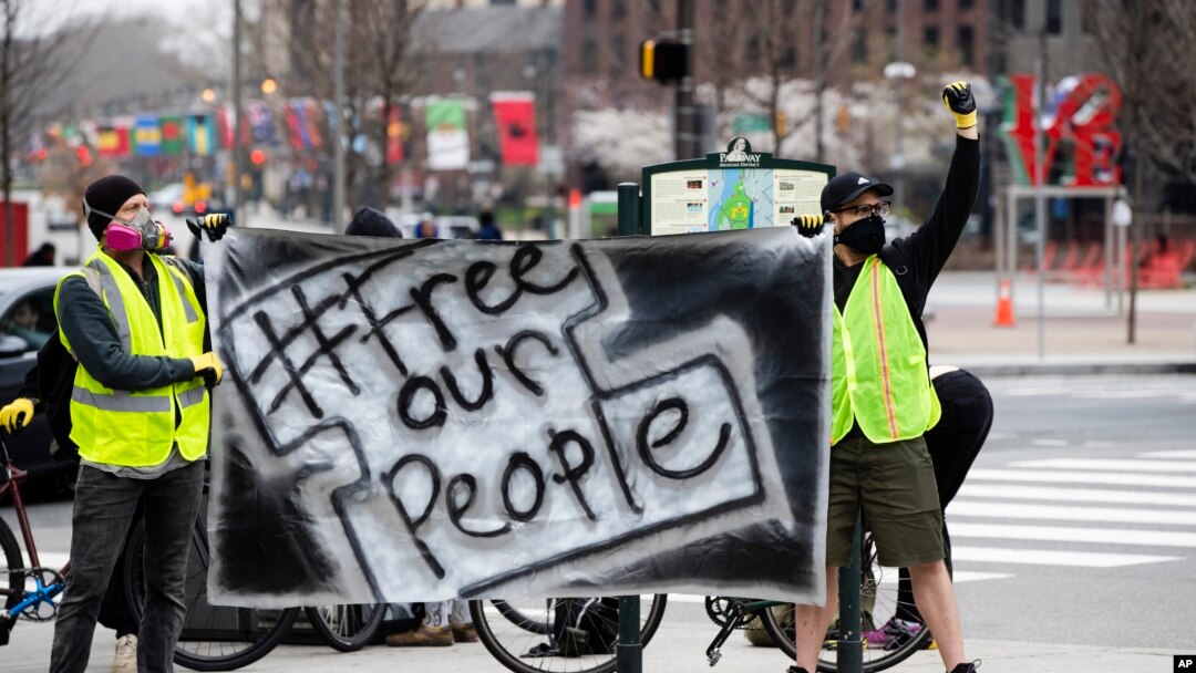(File) Protesters call for officials to release people from jails, prisons, and immigration detention centers in response to the coronavirus, as they demonstrate outside City Hall in Philadelphia, March 30, 2020.