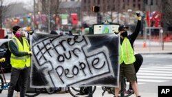 (File) Protesters call for officials to release people from jails, prisons, and immigration detention centers in response to the coronavirus, as they demonstrate outside City Hall in Philadelphia, March 30, 2020.