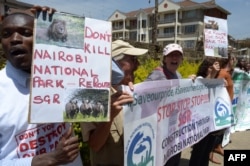 FILE - Demonstrators protest the route of the Standard Gauge Railway (SGR) being built by the Chinese government, which is to cut through the middle of the Nairobi National Park, at a rally outside the People’s Republic of China Embassy in Nairobi, Oct. 17, 2016.
