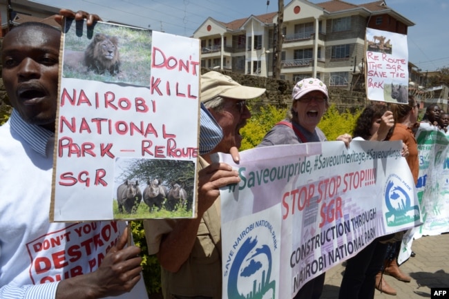 FILE - Demonstrators protest the route of Standard Gauge Railway (SGR) being built by Chinese government, which is to cut through the middle of the Nairobi National Park, at a rally outside the People’s Republic of China Embassy in Nairobi, Oct. 17, 2016.