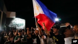 Supporters of former Philippine President Rodrigo Duterte chant slogans outside the Villamor Air Base in Manila, Philippines, March 11, 2025.