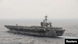 FILE - The aircraft carrier USS Theodore Roosevelt (CVN 71) transits the South China Sea in this U.S. Navy picture taken Oct. 29, 2015. The Philippines has asked the United States to hold joint naval patrols, a defense ministry spokesman said on Thursday, amid a territorial dispute with China in the South China Sea.