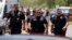 FILE - Police walk near Robb Elementary School following shootings on May 24, 2022, in Uvalde, Texas. A federal report released on Jan. 18, 2024, into the halting law enforcement response to the shootings revived scrutiny of the hundreds of officers who responded to the massacre.