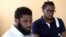 FILE - Rashon Nelson listens to a reporter's question alongside Donte Robinson during an interview with the Associated Press in Philadelphia, April 18, 2018. 
