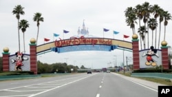FILE - In this Monday, March 16, 2020, file photo, the road to the entrance of Walt Disney World has few cars, in Lake Buena Vista, Fla. Two more unions have reached agreements with Walt Disney World over furloughs caused by the theme park resort's closure. (AP)