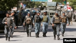 Afghan policemen arrive at the site of an attack and gun fire in Kabul, May 9, 2018. 