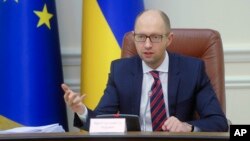 FILE - Ukrainian Prime Minister Arseniy Yatsenyuk speaks during Cabinet in Kyiv, Nov. 25, 2015. 