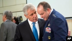 U.S. Secretary of Defense Chuck Hagel, left, speaks with Supreme Allied Commander Europe U.S. General Philip Breedlove during a round table meeting of the North Atlantic Council at NATO headquarters in Brussels, Feb. 5, 2015. 
