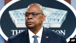 FILE - US Secretary of Defense Lloyd Austin pauses while speaking during a media briefing at the Pentagon, Nov. 17, 2021, in Washington. 