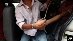 A suspected drug dealer is arrested by Bangladesh's Rapid Action Battalion (RAB) soldiers during a raid on drug dealers at Mohammadpur Geneva Camp in Dhaka, Bangladesh, May 26, 2018. 