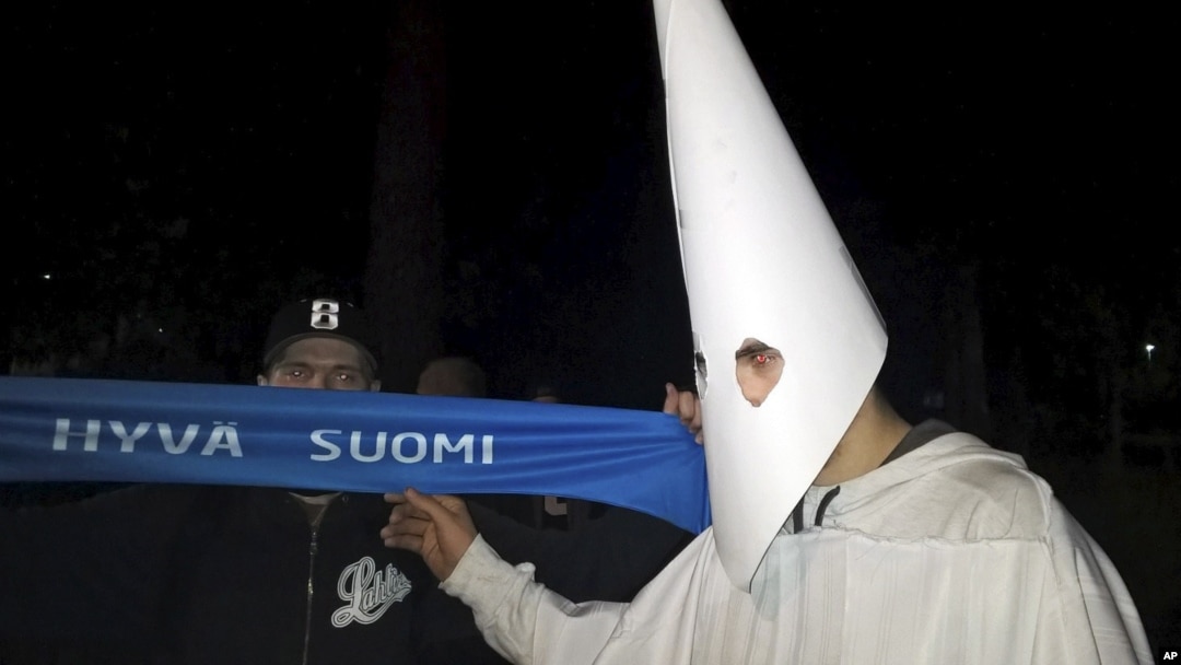 FILE - A demonstrator wearing an outfit in the style of the Ku Klux Klan during a demonstration against refugees in Lahti, Finland, late Thursday September 24, 2015.