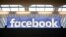 FILE - The Facebook logo is displayed at a gathering for startup companies at Paris' Station F., Jan. 17, 2017.