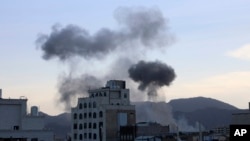 Smoke rises after U.S. aircraft and ships struck Houthi strongholds, according to a U.S. official, in Sanaa, Yemen, Oct. 4, 2024. 