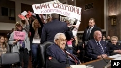 Protesters interrupt a Senate Armed Services hearing on Capitol Hill in Washington, Thursday, January 29, 2015.