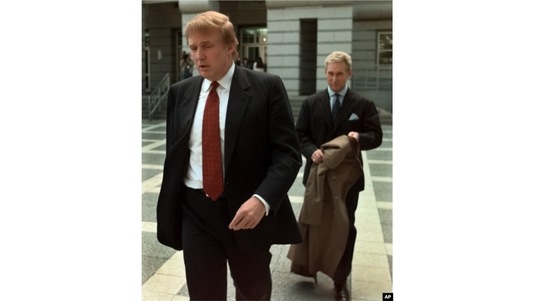FILE - Billionaire real estate developer Donald Trump, left, walks to the Federal Courthouse in Newark, N.J., with Roger Stone, the director of Trump's presidential exploratory committee, Oct. 25, 1999, for the swearing-in of Trump's sister as a federal appeals court judge.