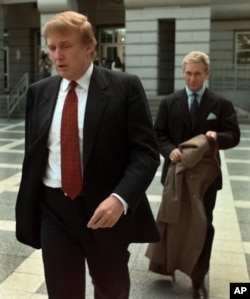 FILE - Billionaire real estate developer Donald Trump, left, walks to the Federal Courthouse in Newark, N.J., with Roger Stone, the director of Trump's presidential exploratory committee, Oct. 25, 1999, for the swearing-in of Trump's sister as a federal appeals court judge.