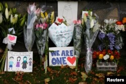 Flowers and signs are seen at a memorial as tributes to victims of the mosque attacks near Linwood mosque in Christchurch, New Zealand, March 16, 2019.