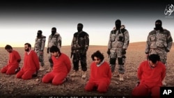 This undated image is taken from video posted online Jan. 3, 2016, by the Islamic State group. The group claims it shows its members executing five men they accuse of spying for Britain in Syria.