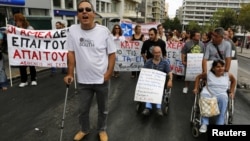Disabled Greeks march during a rally against new austerity measures, in central Athens, September 12, 2012.