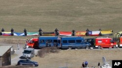 Flags representing different nations are deployed during a ceremony in front of a memorial for victims in the area where the Germanwings jetliner crashed in the French Alps, Le Vernet, France, March 3, 2015. 