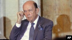 Commerce Secretary Wilbur Ross listens to translation as Chinese Vice Premier Wang Yang speaks at the opening of the U.S.-China Comprehensive Economic Dialogue at the Treasury Department in Washington, July 19, 2017.