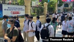 Students are seen near a school as more than a million high school students take graduation exams across the country amid a sharp rise in COVID-19 infections in recent days in Hanoi, Vietnam, July 7, 2021.