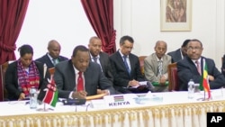 In this photo released by the Kenyan Presidential Press Service, Kenyan President Uhuru Kenyatta, left, speaks during the meeting on the situation in South Sudan, held at State House, Nairobi, Kenya, Friday, Dec. 27, 2013. On the right is Ethiopian Prime Minister Hailemariam Dessalegn (AP Photo/Kenyan Presidential Press Service)