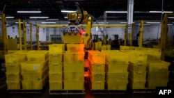 A robot organizes containers at the 855,000-square-foot Amazon fulfillment center in Staten Island, one of the five boroughs of New York City, Feb. 5, 2019.