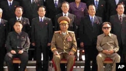 In this undated photo released on Thursday, Sept. 30, 2010, by Korean Central News Agency, North Korean Leader Kim Jong Il, right, poses for a group photo with newly elected members of the central leadership body of the Workers Party of Korea and the part