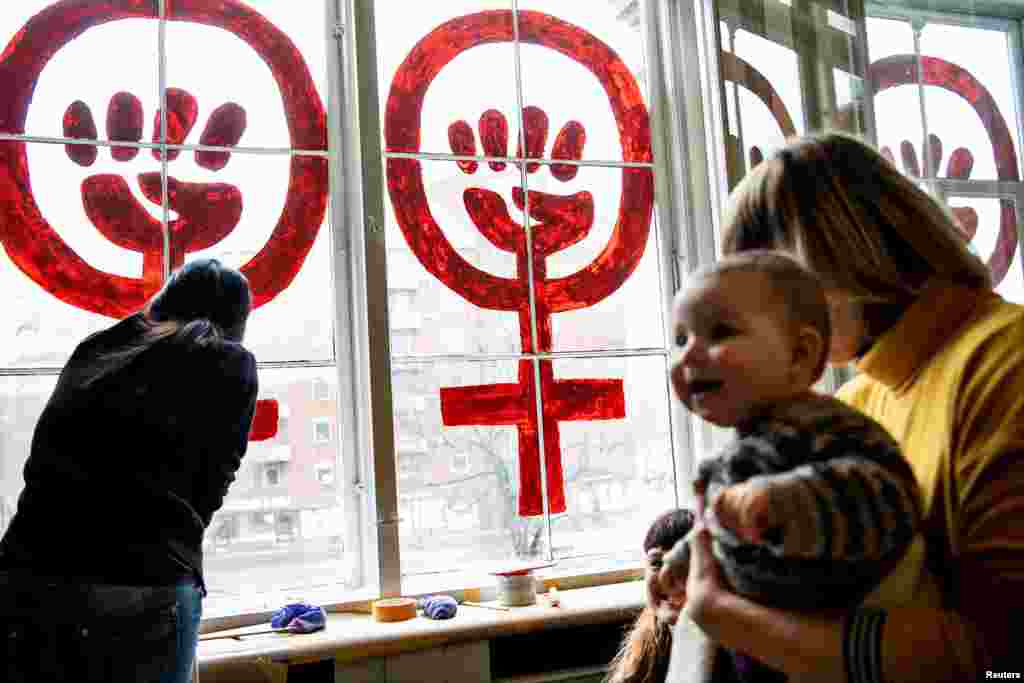 "Woman Power" symbol is repainted on the windows of the Danner Foundation's house in Copenhagen, Denmark, March 8, 2019.