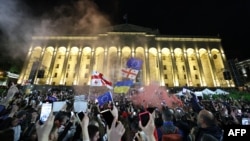 Protesters rally against the "foreign influence" law outside the parliament in Tbilisi, Georgia, on May 15, 2024. Georgian President Salome Zourabichvili vetoed the recently passed measure on May 18, 2024.