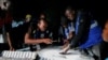 Electoral officials count votes during the presidential and parliamentary election at a polling station in Bole, Ghana, Dec. 7, 2024.