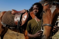 Behind Fallou Diop, a 19-year old horse jockey, you can see the saddle on his horse named Raissa Betty, in Niaga, Rufisque region, Senegal, January 27, 2021. (REUTERS/Zohra Bensemra)