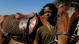 Behind Fallou Diop, a 19-year old horse jockey, you can see the saddle on his horse named Raissa Betty, in Niaga, Rufisque region, Senegal, January 27, 2021. (REUTERS/Zohra Bensemra)