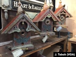 Artisan John Guertin combines his love of architecture and the environment by creating one-of-a-kind birdhouses and feeders using wood from century-old barns from his home state of Michigan.