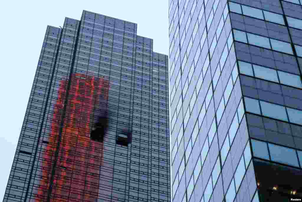 Damaged windows are seen after a fire broke out in an apartment in Trump Tower in Manhattan in New York City, April 7, 2018.