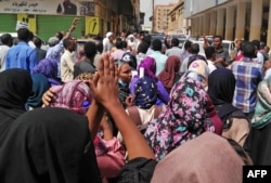 Sudanese protesters take part in an anti-government demonstration in Khartoum, Feb. 14, 2019.