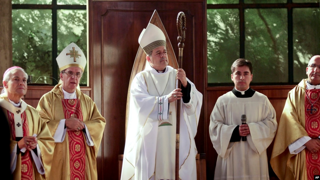 FILE - Monsignor Juan Barros, center, attends his ordination ceremony as bishop in Osorno, southern Chile, March 21, 2015. Pope Francis accept the resignations of three Chilean bishops, June 11, 2018, including the cleric accused of failing to stop a pedophile priest decades ago.