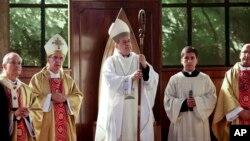 FILE - Monsignor Juan Barros, center, attends his ordination ceremony as bishop in Osorno, southern Chile, March 21, 2015. Pope Francis accept the resignations of three Chilean bishops, June 11, 2018, including the cleric accused of failing to stop a pedophile priest decades ago.