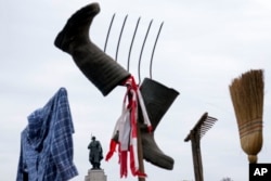 FILE—A farmer's shirt, boots, pitchfork and broom is seen during a protest in Berlin, Germany, March 22, 2024.