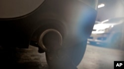 Exhaust fumes escape from the exhaust of a diesel engine car in Paris, Oct.14 2015. 