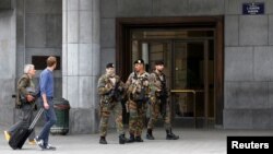Belgian soldiers patrol outside the central train station where a suspect package was found, in Brussels, June 19, 2016. 