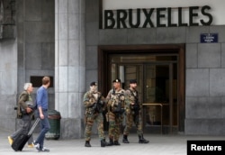 Belgian soldiers patrol outside the central train station where a suspect package was found, in Brussels, Belgium, June 19, 2016.