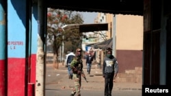 FILE - A soldier patrols the streets ahead of planned anti-government protests amid the coronavirus pandemic, in Harare, Zimbabwe, July 30, 2020.