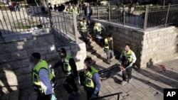 Israeli ZAKA emergency response members carry the bodies of Palestinians at the scene of a shooting attack near the Damascus gate, Jerusalem's Old City, Feb. 3, 2016.