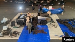 Investigators inspect the burned Tesla Cybertruck after it exploded in front of the Trump International Hotel in Las Vegas, Jan. 2, 2025. (Las Vegas Metropolitan Police Department/Handout via Reuters)