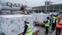 Airport officials receive boxes of Moderna coronavirus vaccine after their arrival at the airport in Nairobi, Kenya, Sept. 6, 2021. 